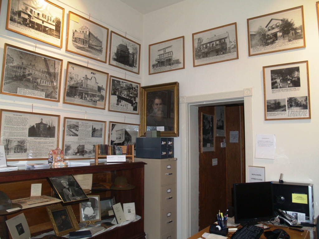 Office Area, Whistle Junction Visitor's Center and Museum.  Displayed on the walls are photographs collected by the Ringo sisters and framed for the 1957 Iron County Centennial Celebration.  The offices of the Arcadia Valley Chamber of Commerce and the Iron County Historical Society are also in this room.  The room also contains a display on local scouting and Civil War era artist, James Hinchey.  One of the two filing cabinets contains the Hardy Negative Collection and the other miscellaneous materials.